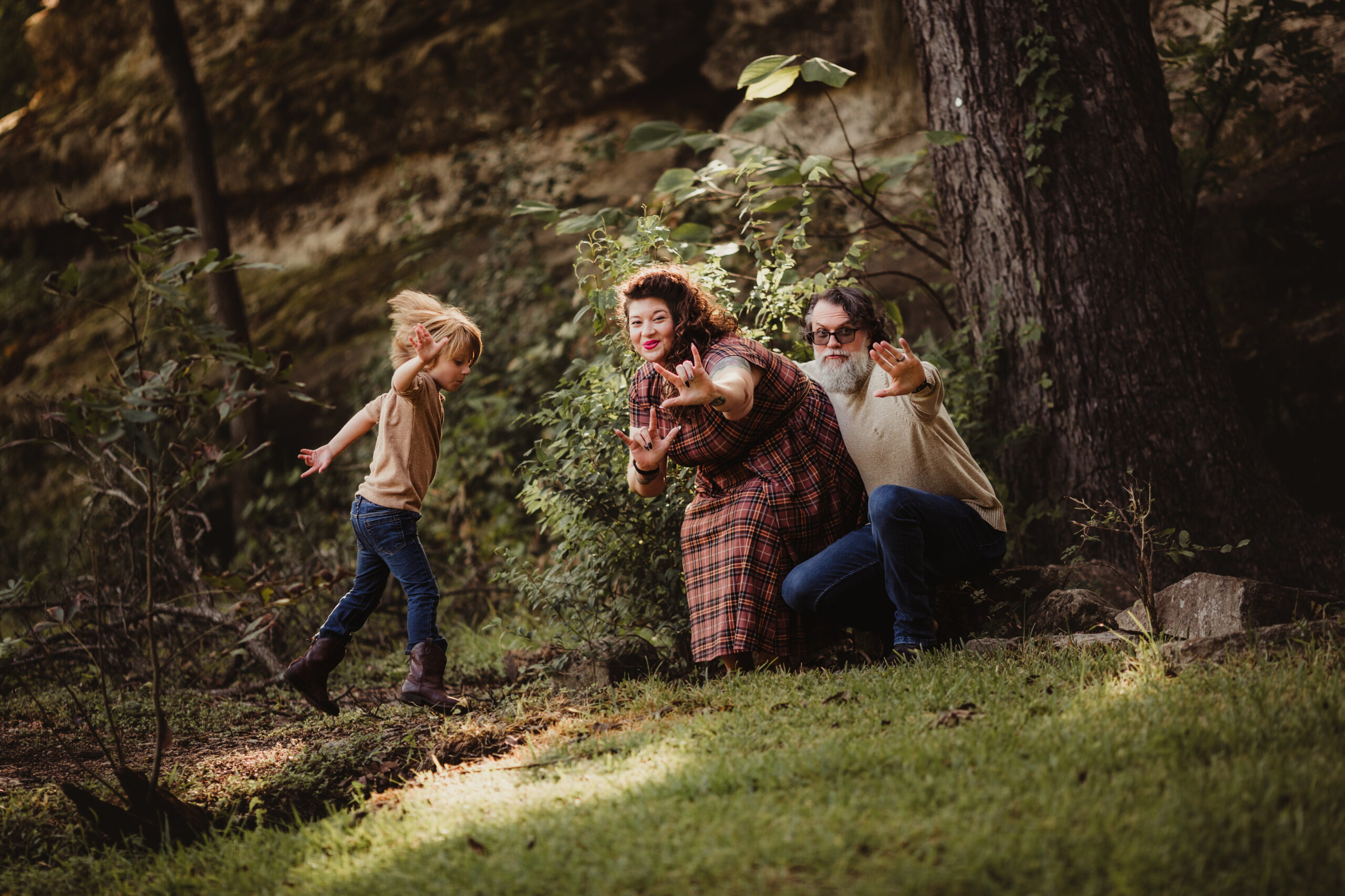 A family playing in a sunbeam for a photo session